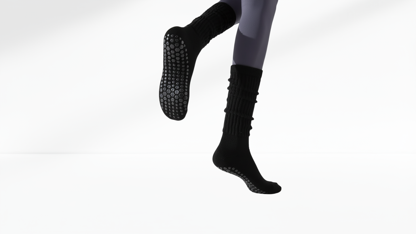 Black grip socks with textured sole on a white background