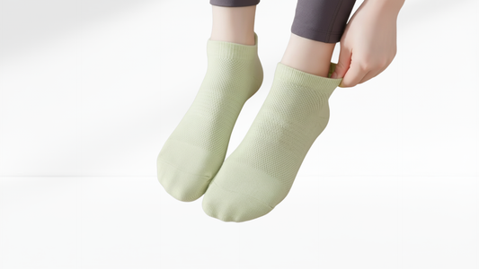 Light green grip socks worn by a person on a white background