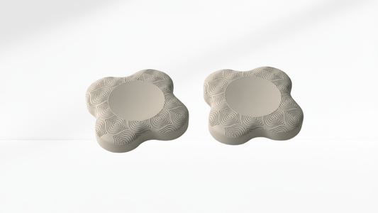 Two grey foam elbow support pads with curved ergonomic shape and swirl texture, shown on a white background.