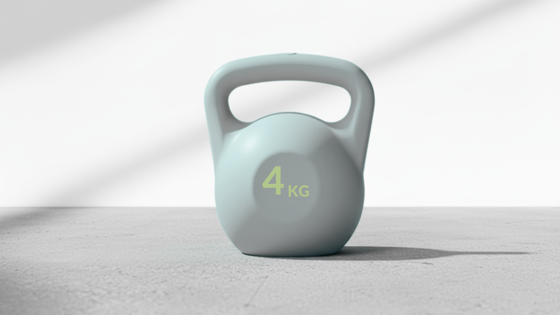 4kg light grey kettlebell on a gray surface with a white background