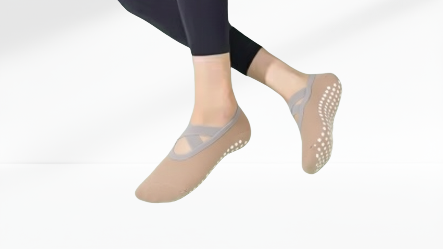 Beige grip socks ballet with gray grips worn by a person on a white background