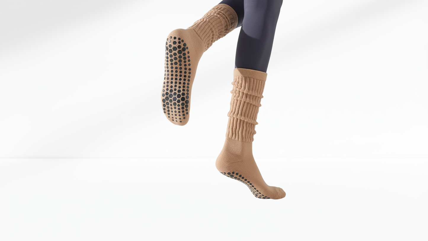 Beige grip socks with textured sole on a white background