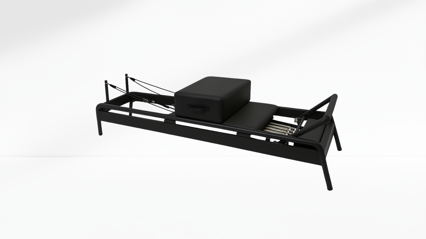 Black Pilates Reformer with a box on a white background