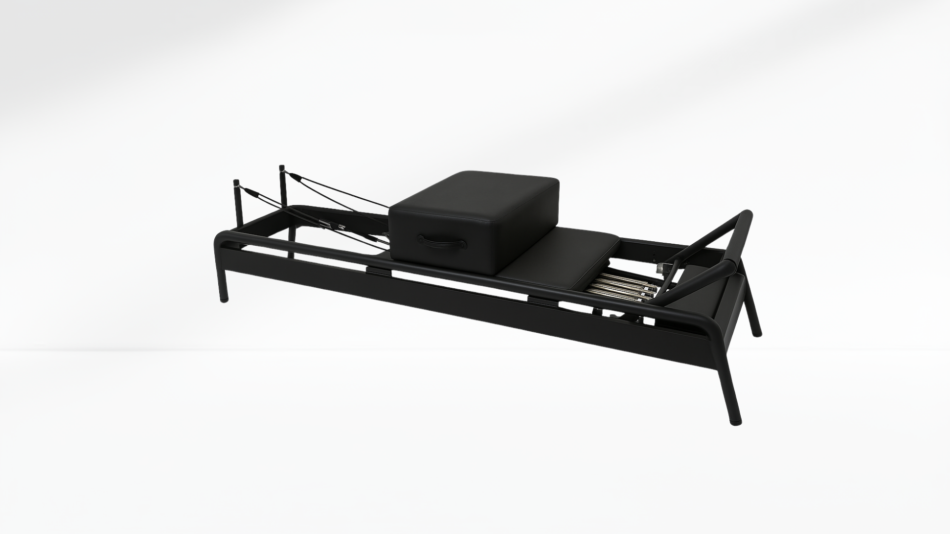 Black Pilates Reformer with a box on a white background
