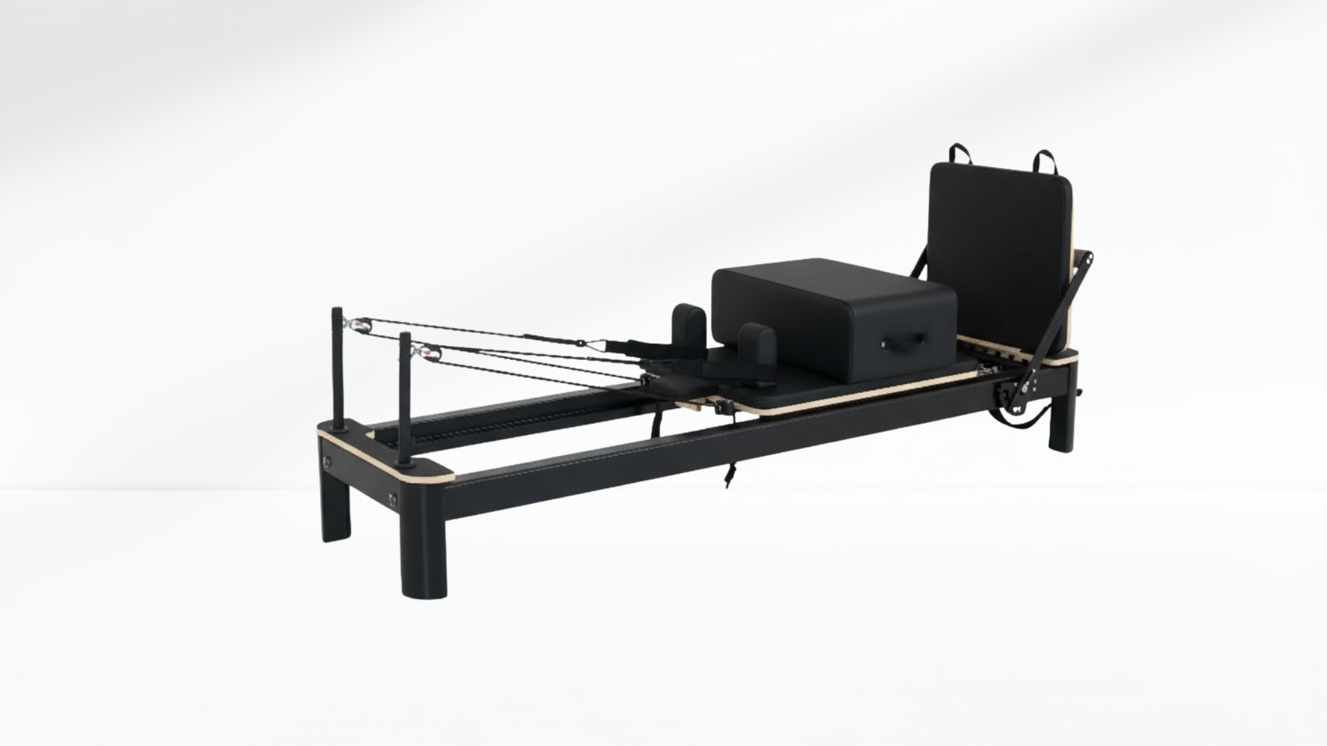 Black Pilates reformer on a white background