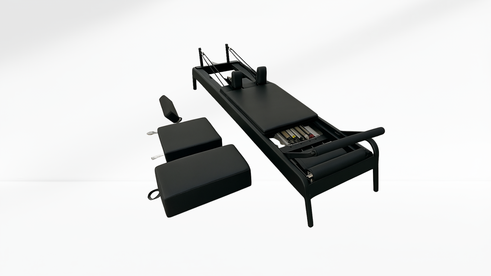 Black Pilates reformer with the box on a white background