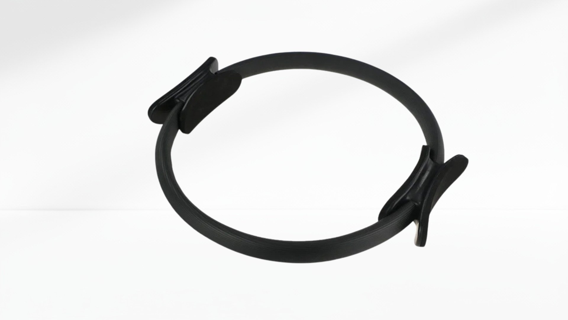 Black Pilates ring with black accents on a white background