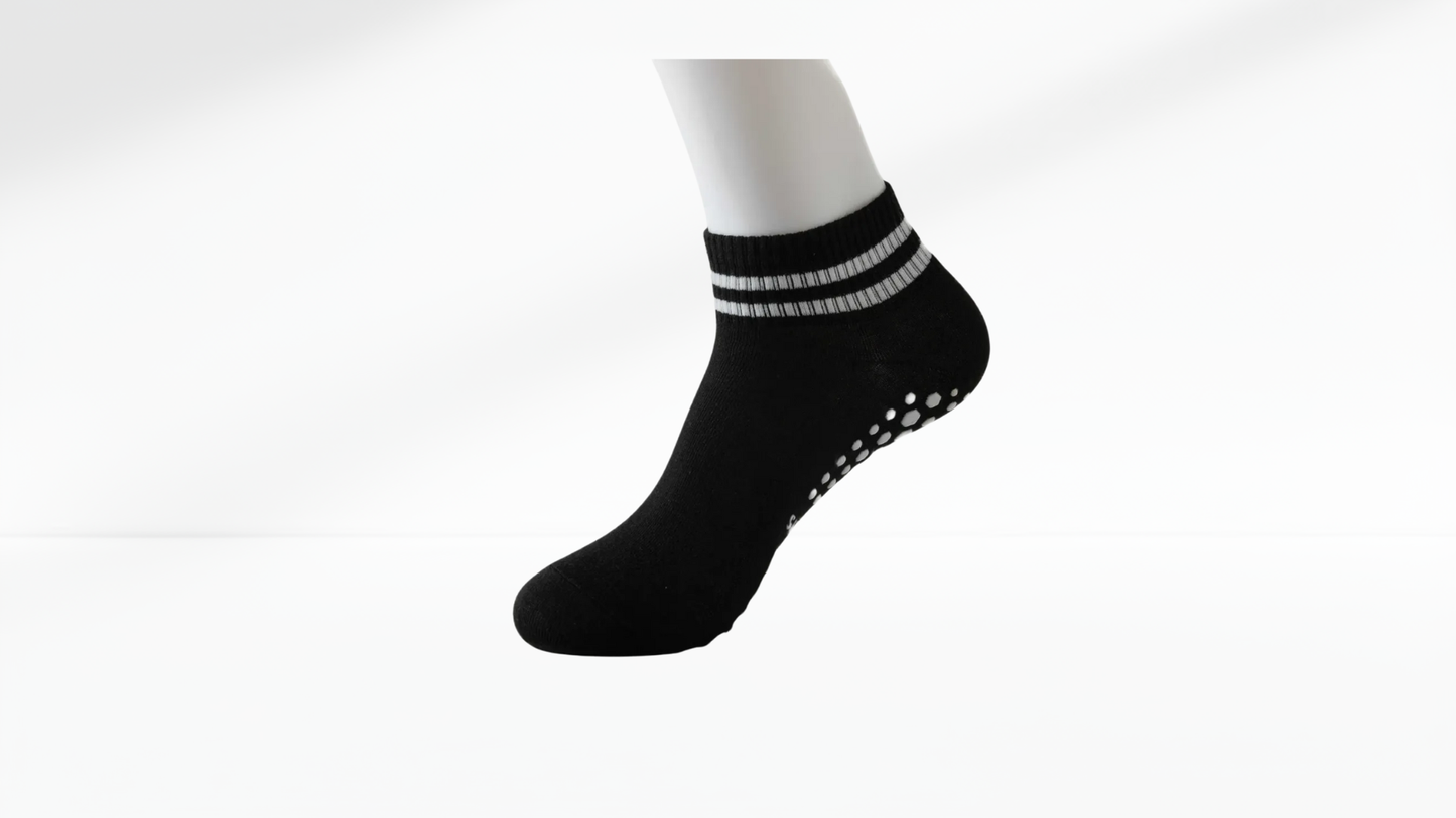 Black ankle grop sock with white stripes on a white background