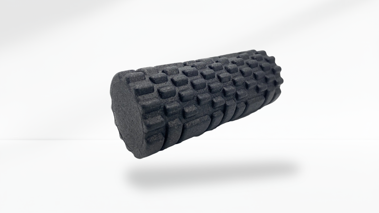 Black foam roller on a white background