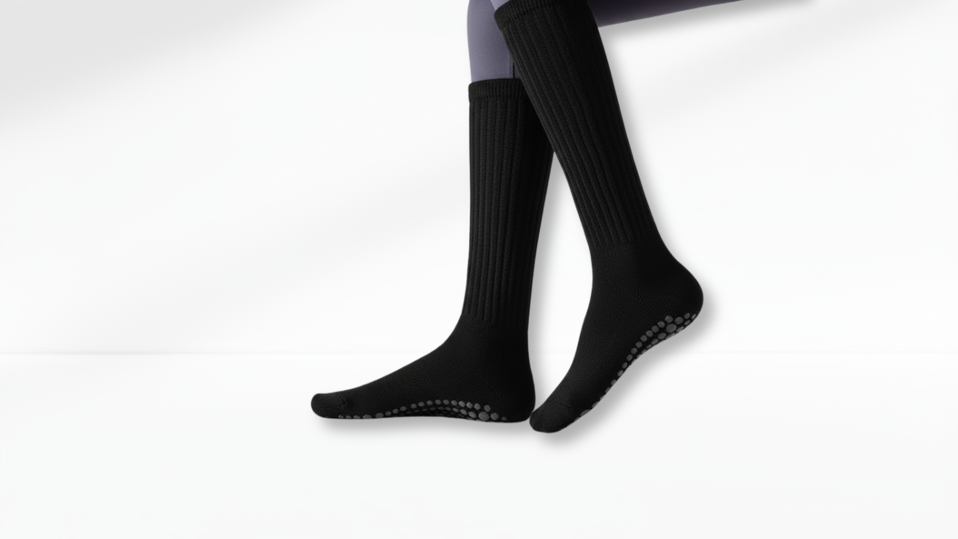Black grip socks with grip sole on a white background