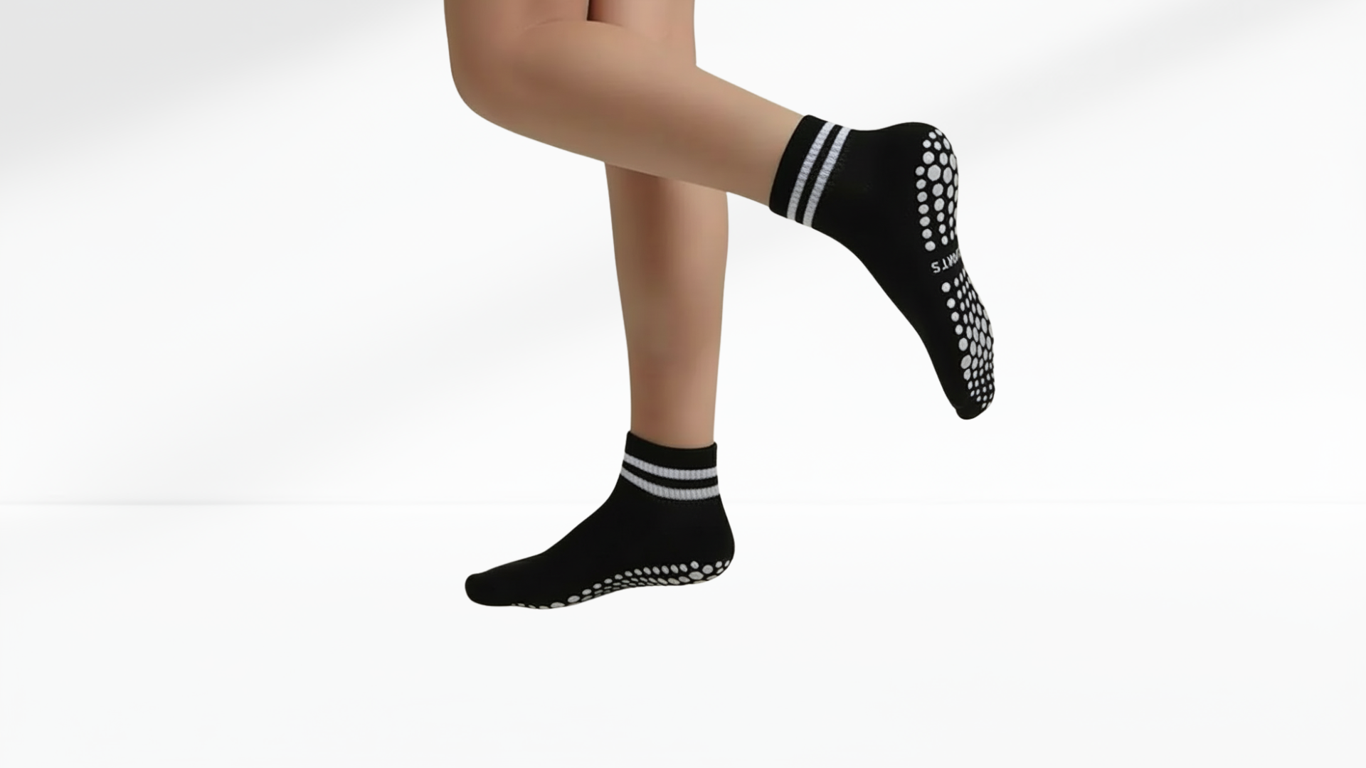 Black grip socks with white stripes worn by a person on a white background