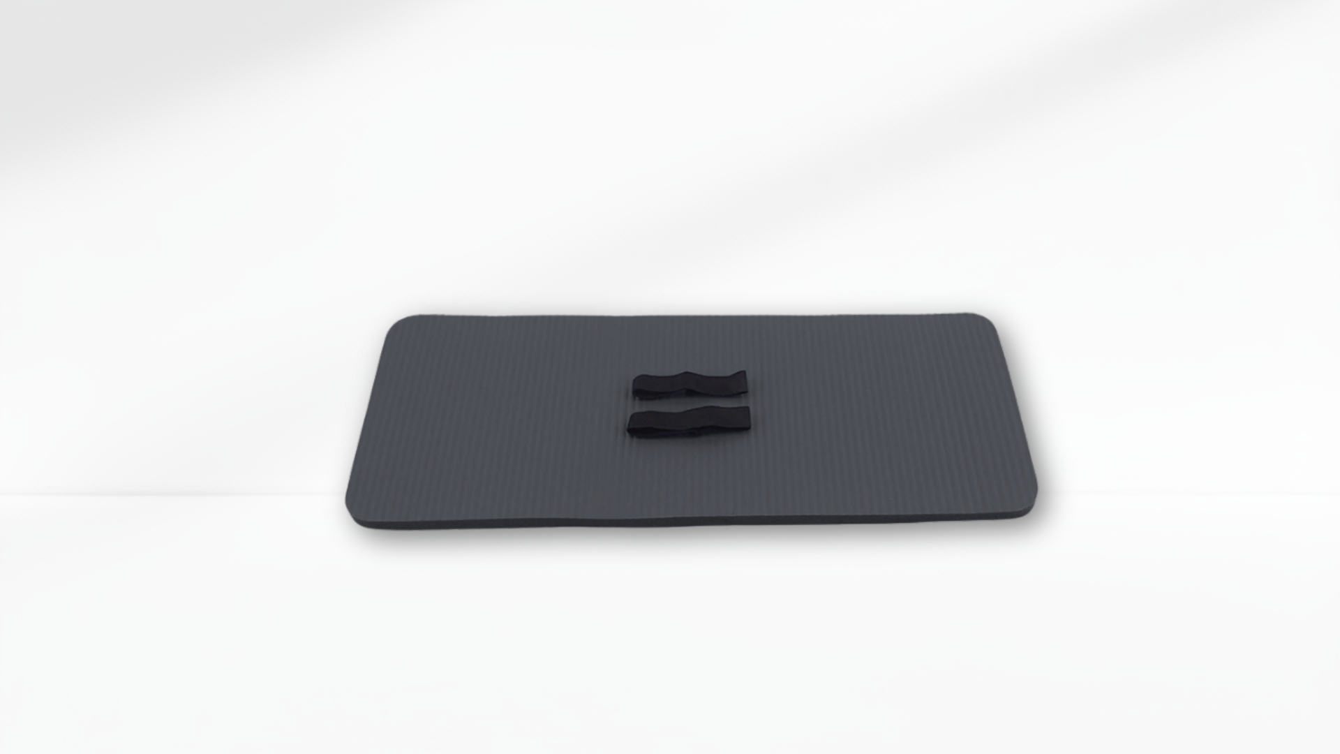 Black mat object with a central indentation on a white background