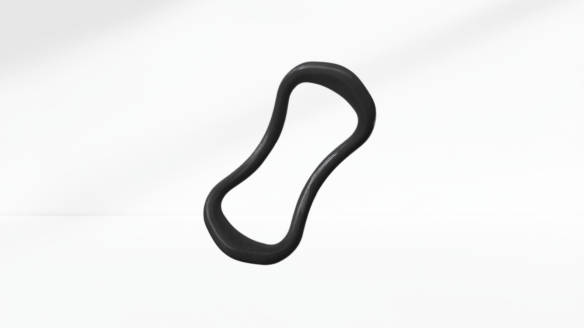 Black pilates ring on a white-grey background