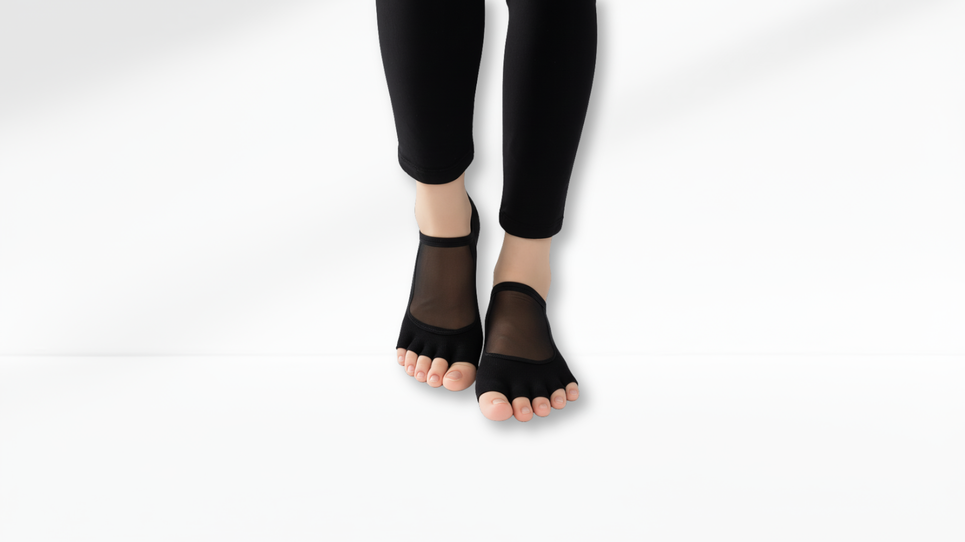 Black sheer Toe Socks Mesh Grip worn with black leggings on a white background