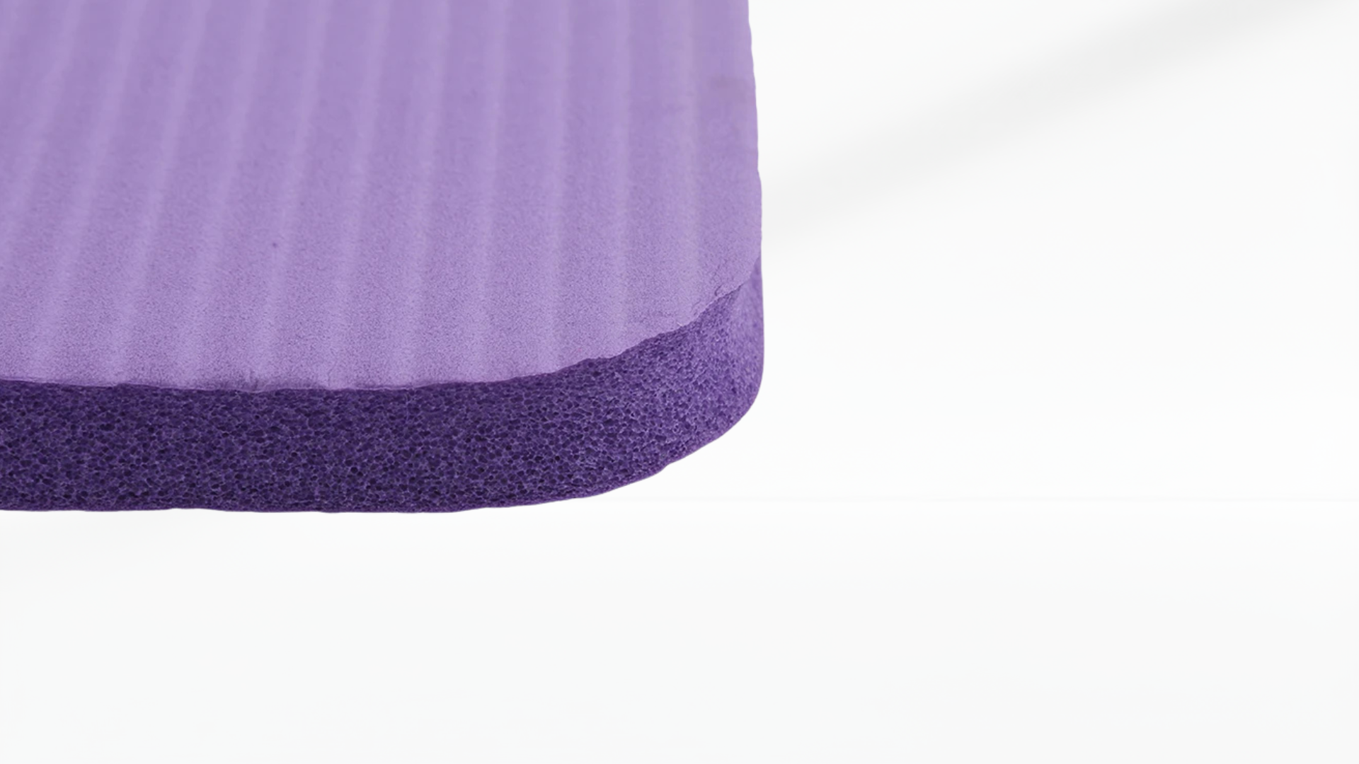 Close-up of a purple mat textured fabric with a white background