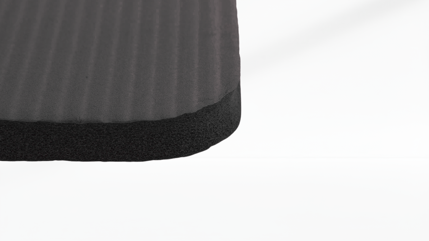 Close-up of a textured black mat corner on a white background