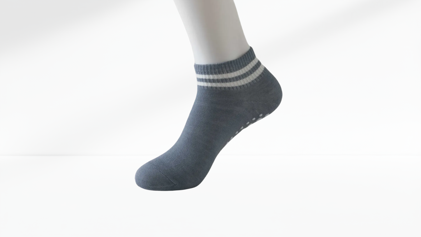 Gray ankle grip sock with white stripes on a white background