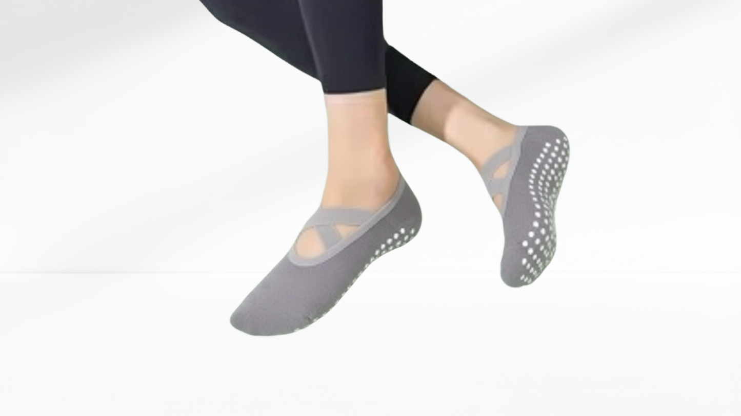 Gray slip-on grip sock ballet  with textured sole worn by a person on a white background