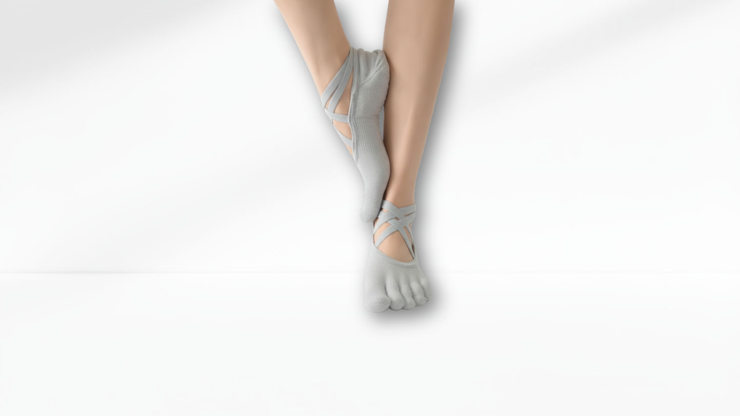 Gray toe-separated socks worn by a person on a white background