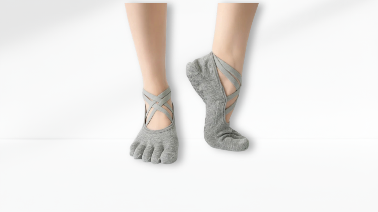 Gray toe-separated socks worn on a white background