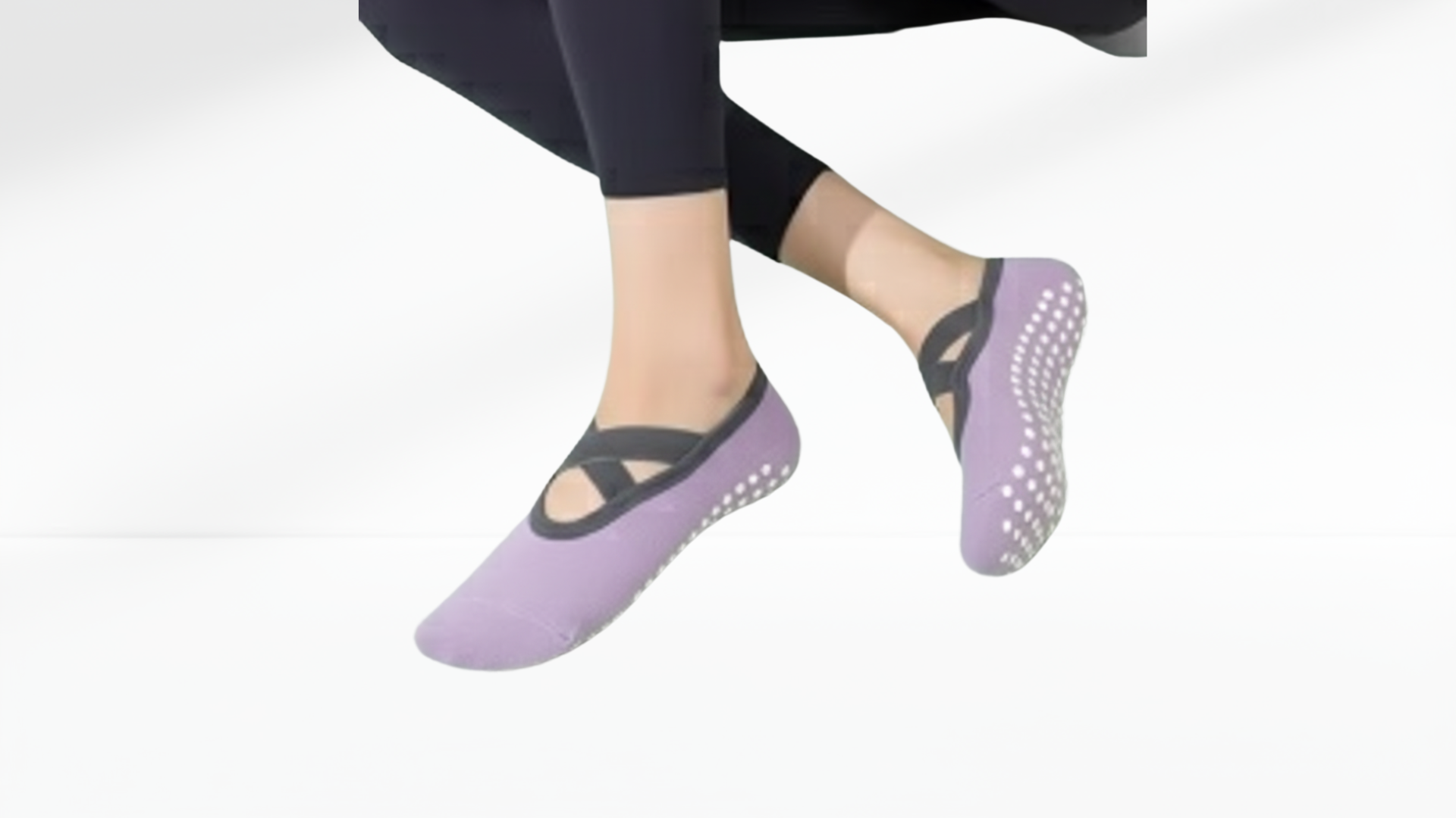 Green slip-resistant grip socks ballet worn by a person on a white background