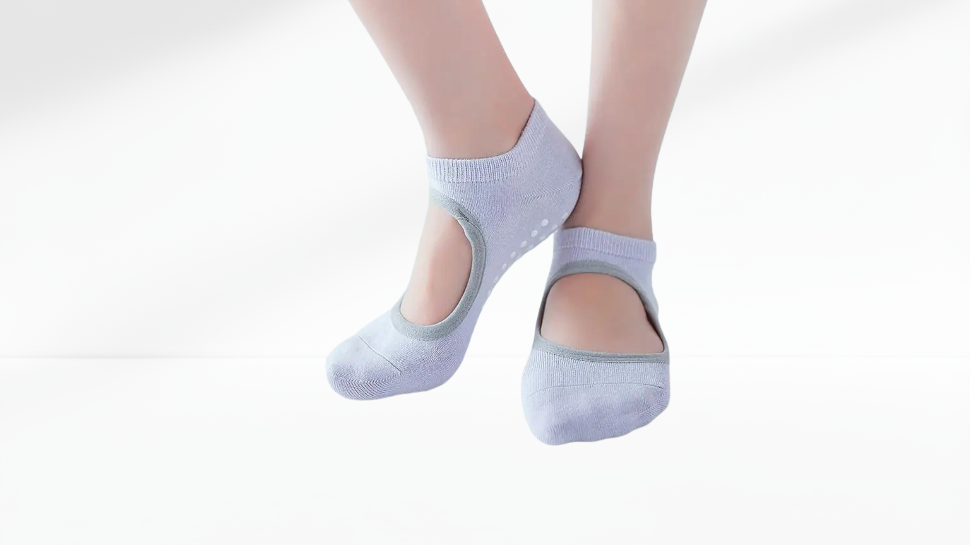 Light blue ankle grip socks worn by a person on a white background