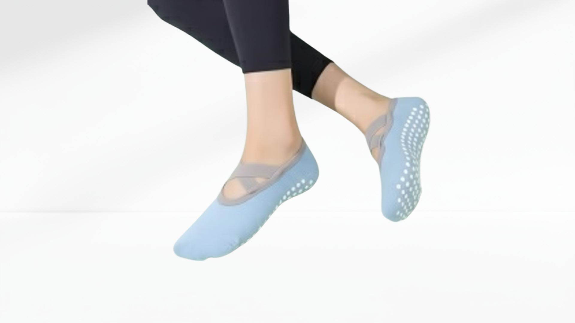 Light blue non-slip grip socks ballet worn by a person on a white background
