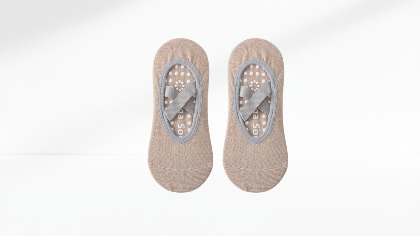 Pair of beige no-show grip socks ballet with gray arch support on a white background