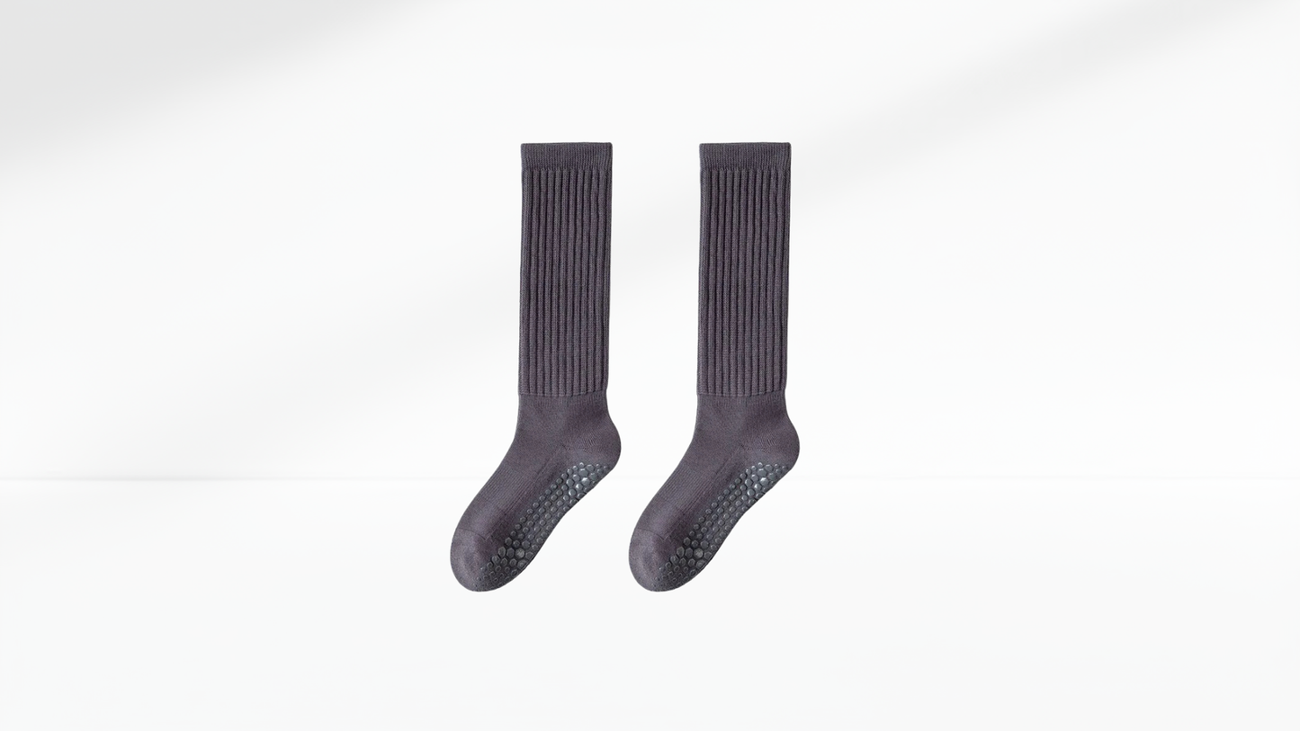 Pair of dark gray grip socks on a white background