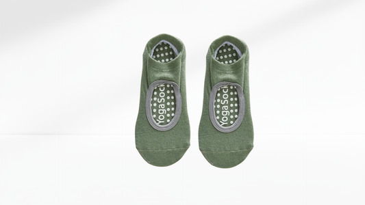 Pair of green grip socks with gray sole on a white background