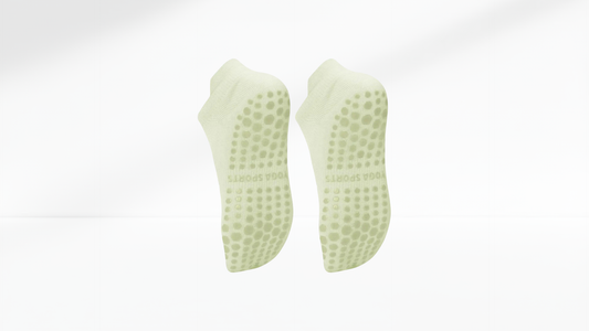 Pair of green textured grip socks on a white background