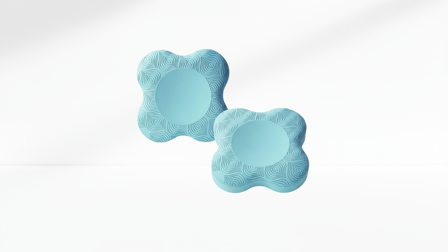 Pair of light-blue ergonomic elbow pads with textured surface, displayed on a clean white background.