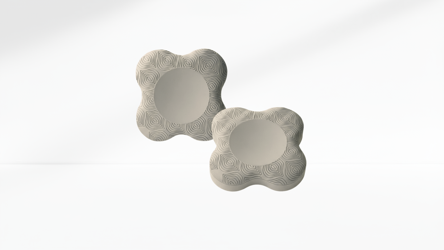 Pair of light-grey ergonomic elbow pads with textured surface, displayed on a clean white background.