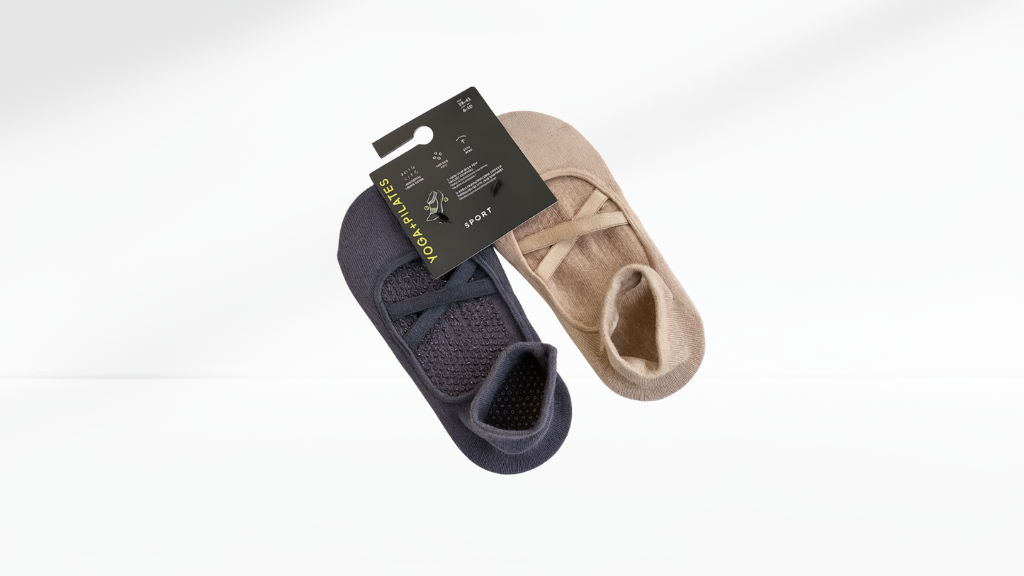 Pair of navy and beige grip socks with a brand label on a white background