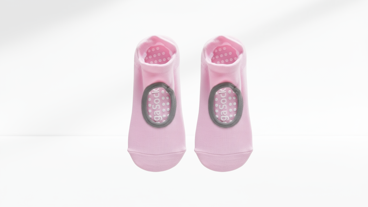 Pair of pink grip socks with a brand logo on a white background