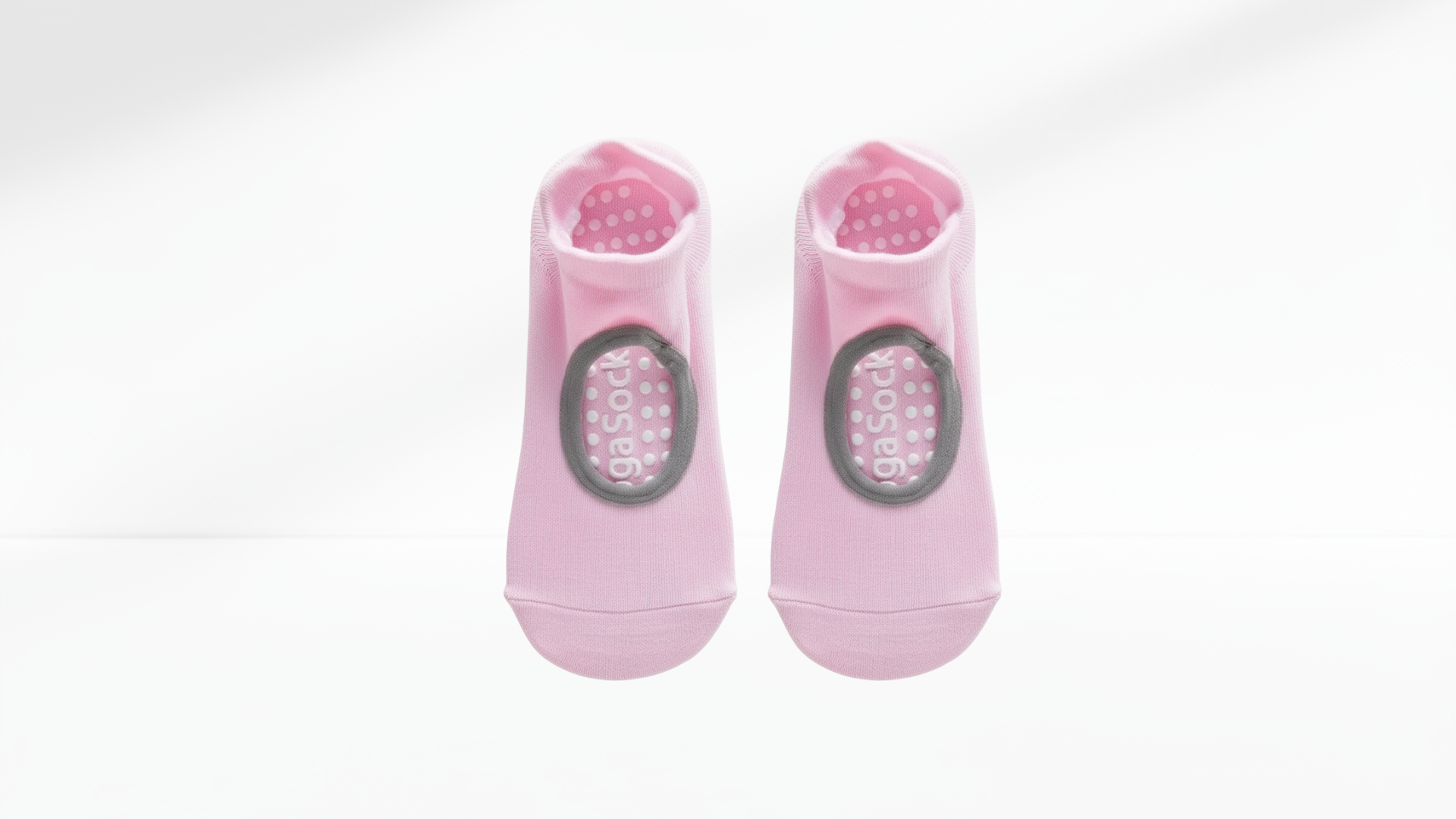 Pair of pink grip socks with a brand logo on a white background
