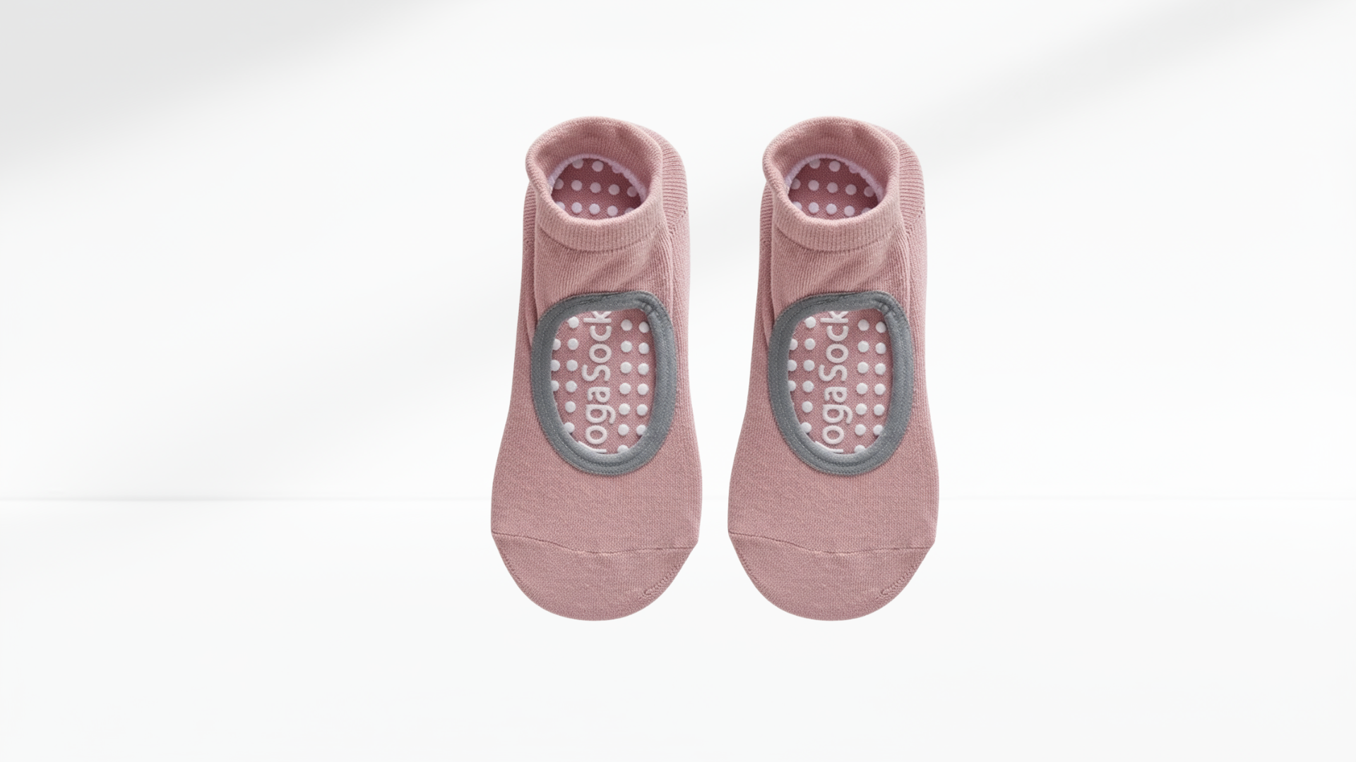Pair of pink grip socks with sole covers on a white background