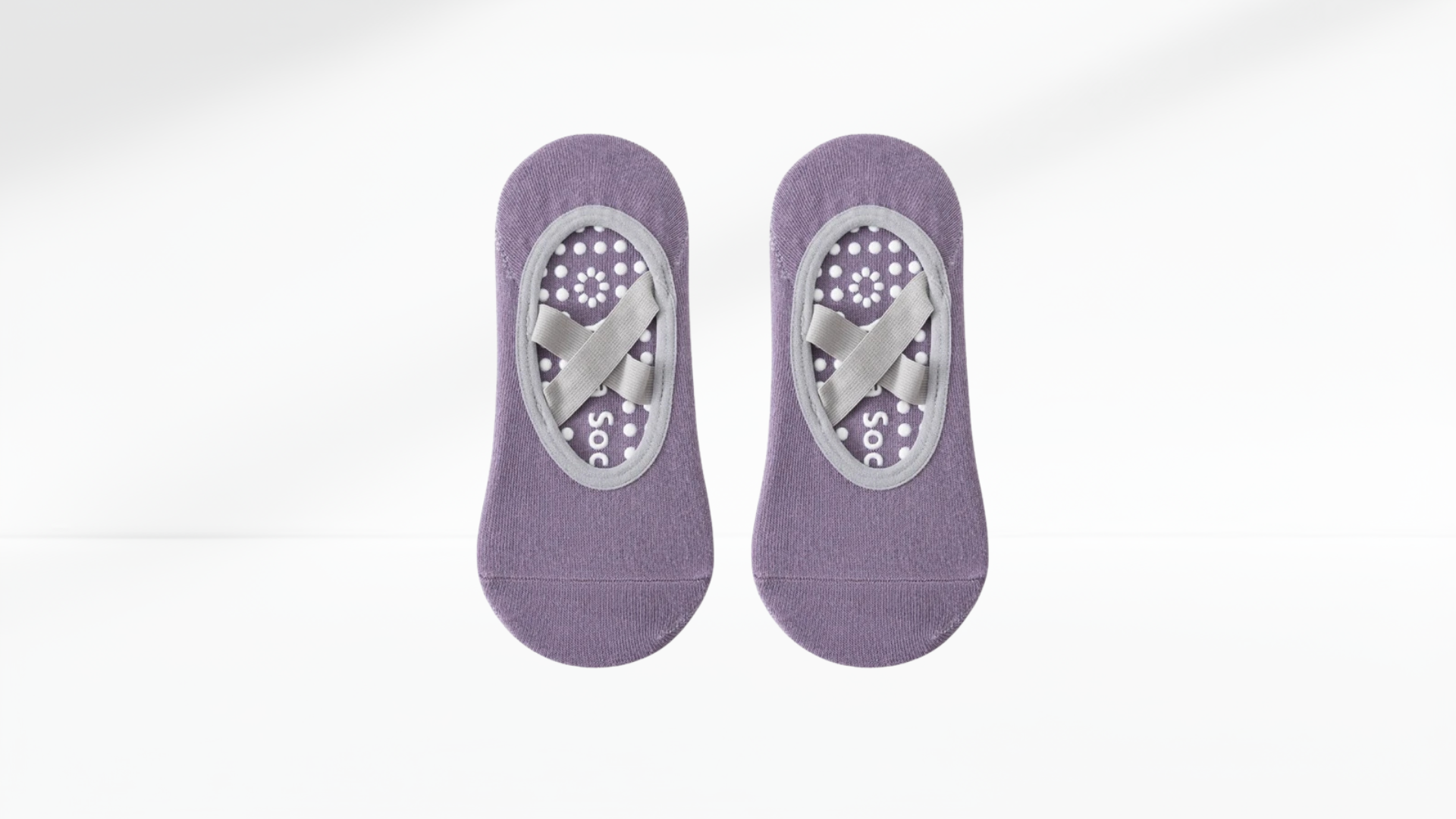Pair of purple ankle grip socks ballet  with gray heel and toe pads on a white background