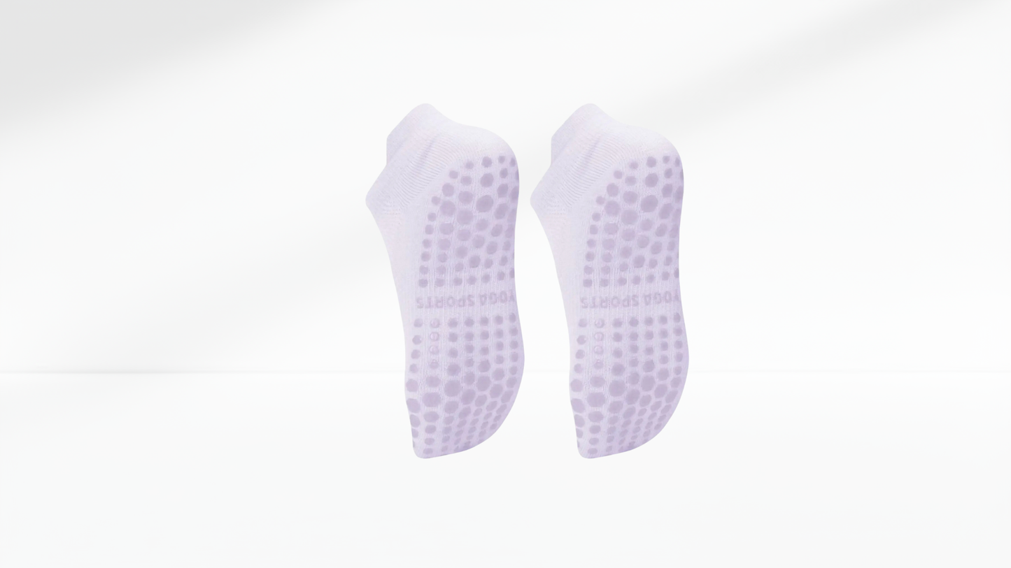 Pair of purple grip socks with textured sole on a white background