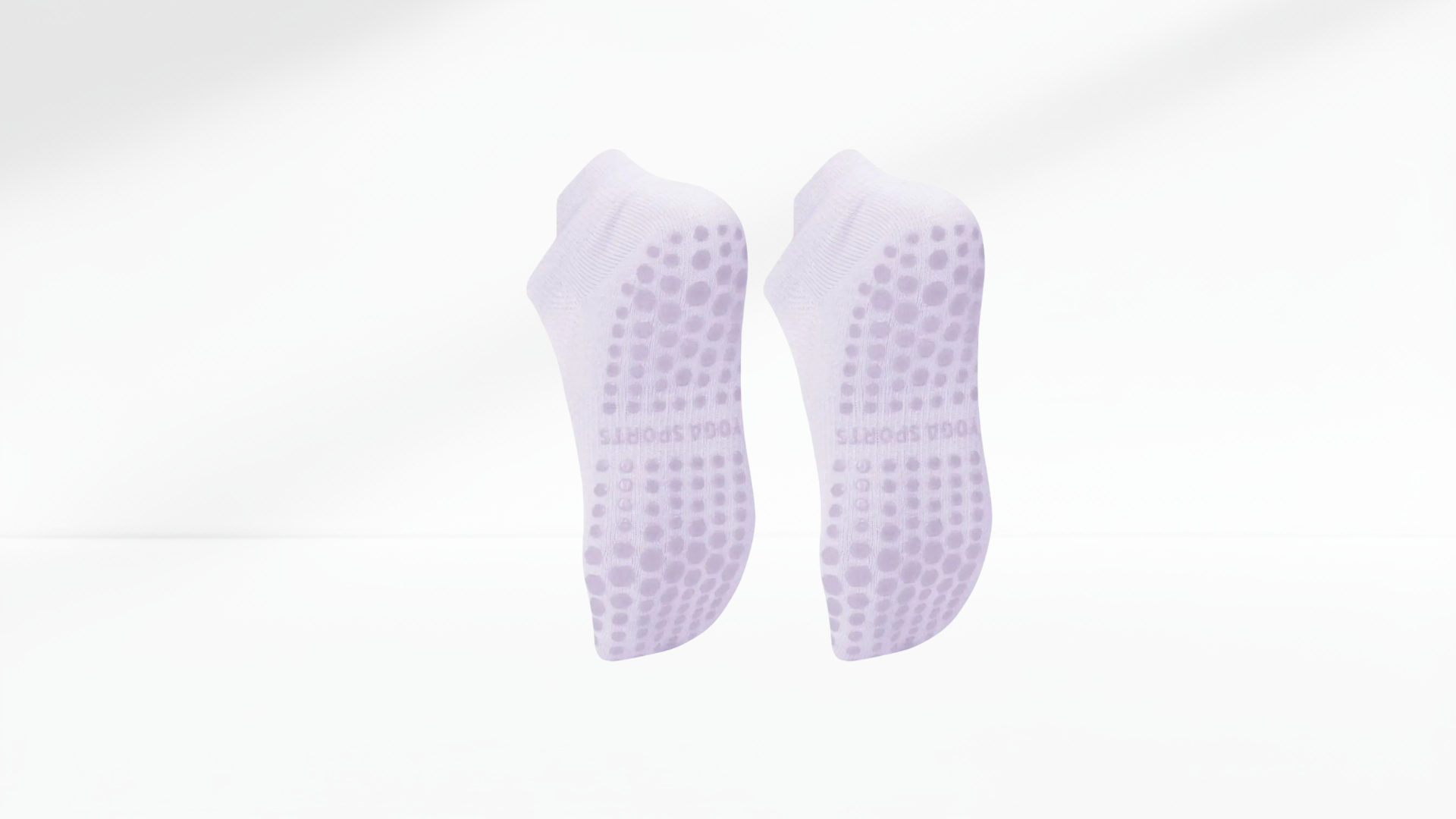 Pair of purple grip socks with textured sole on a white background