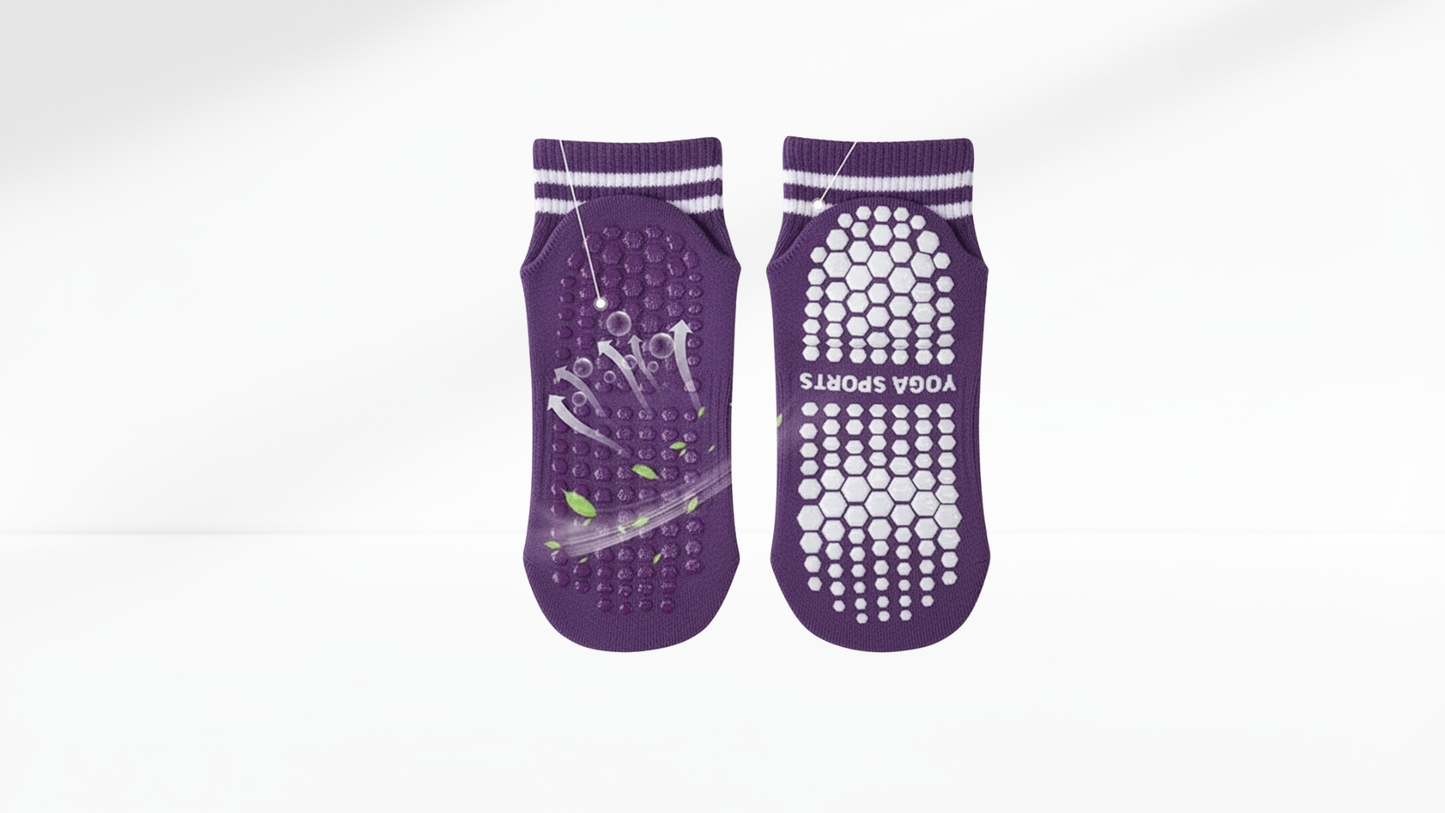Pair of purple massage grip socks with white accents on a white background