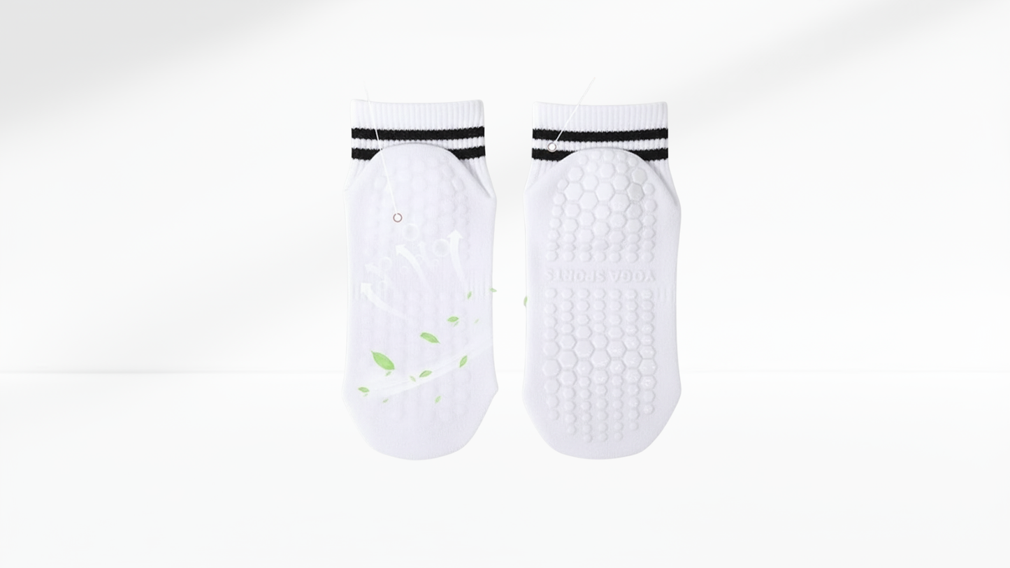 Pair of white grip socks with black bands on a white background