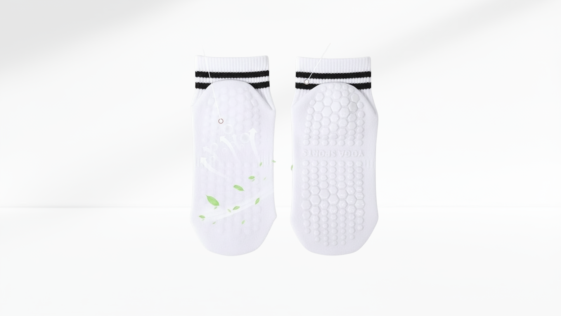 Pair of white grip socks with black bands on a white background