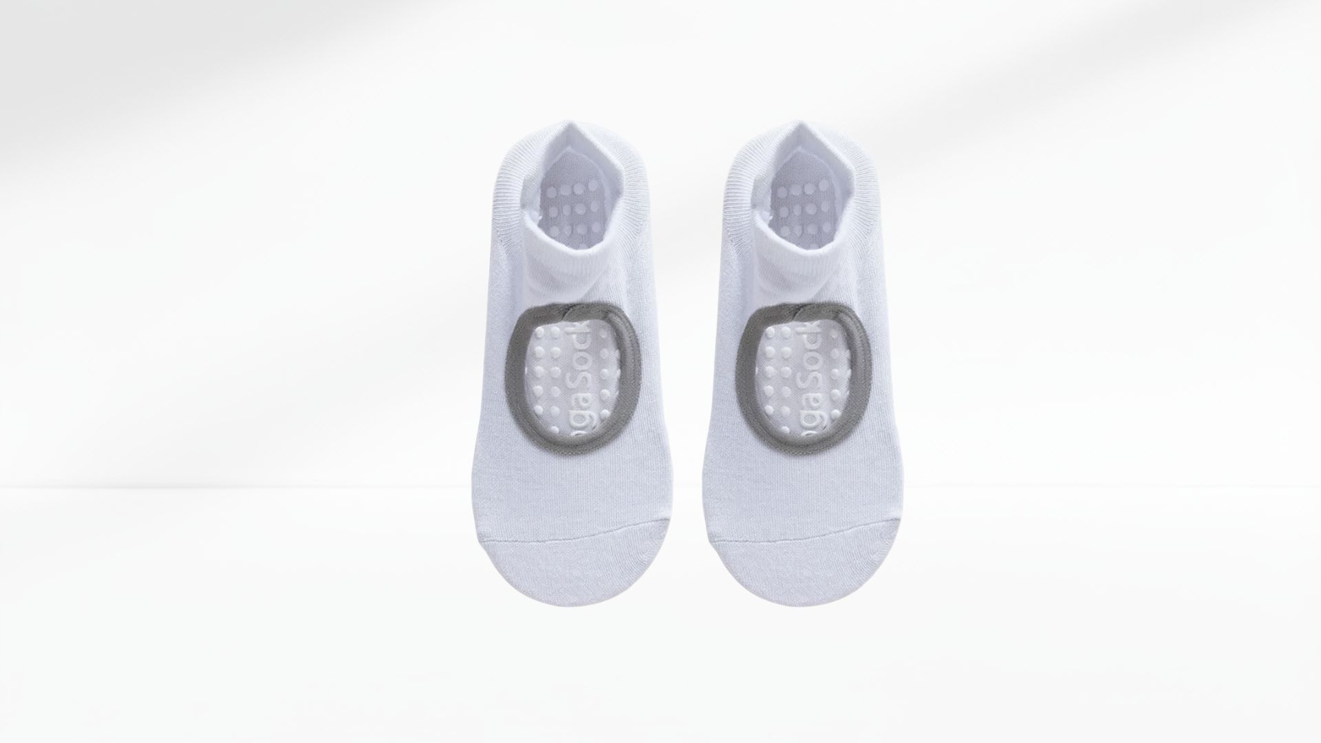 Pair of white grip socks with gray accents on a white background