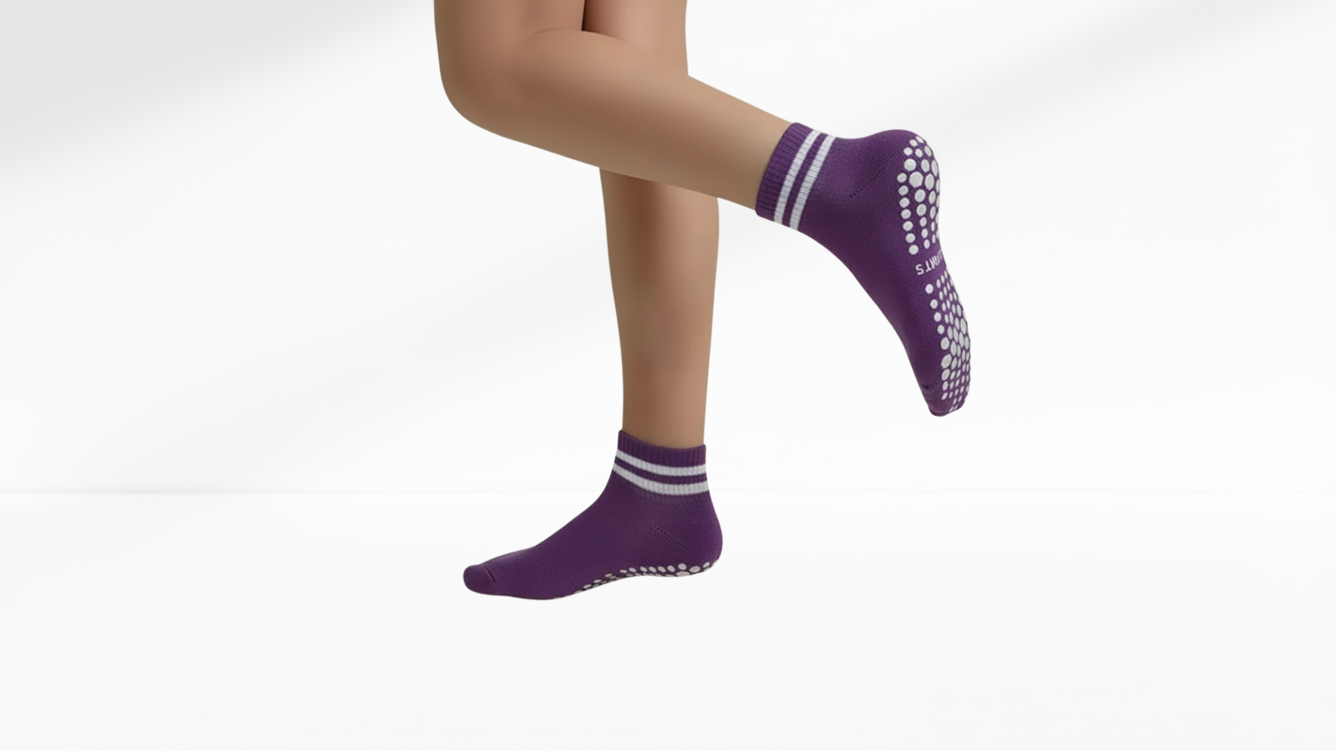 Person with  purple grip socks on a white background