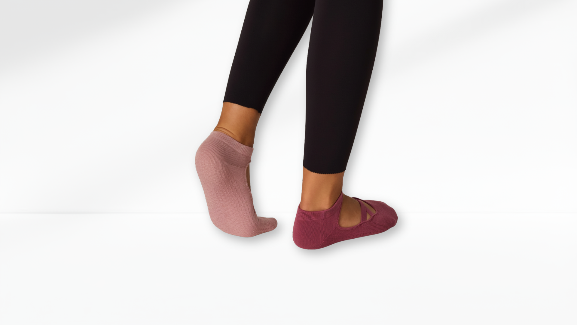 Person wearing black leggings and pink Grip Socks – Ballet Mary Jane on a white background