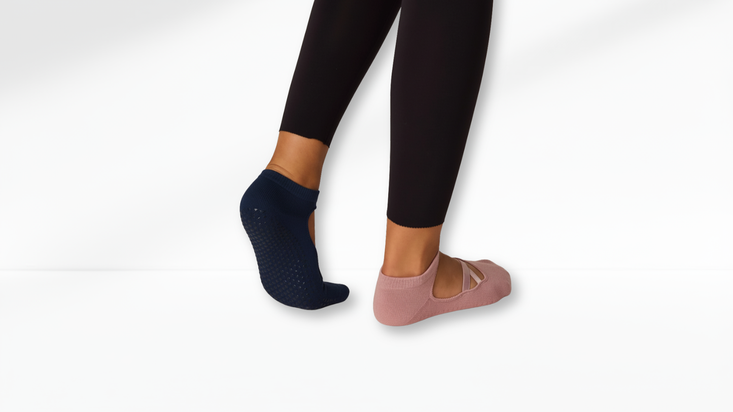 Person wearing black leggings and two different pairs of Grip Socks – Ballet Mary Jane on a white background