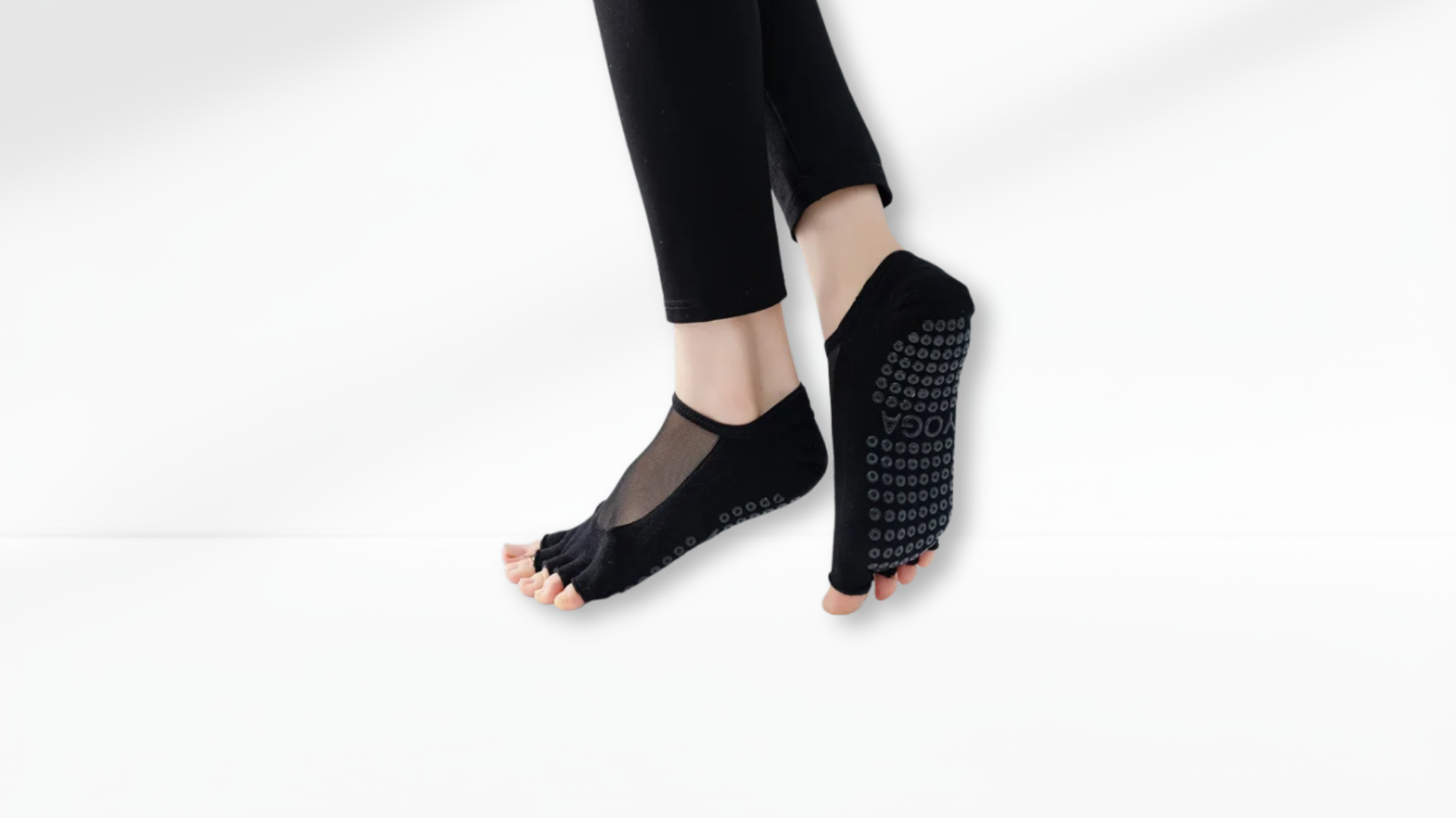 Person wearing black yoga Toe Socks Mesh Grip on a white background
