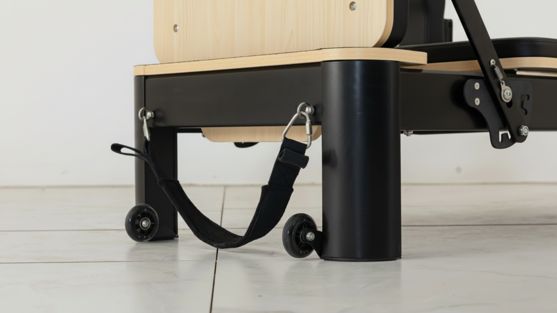Pilates reformer machine on a white floor