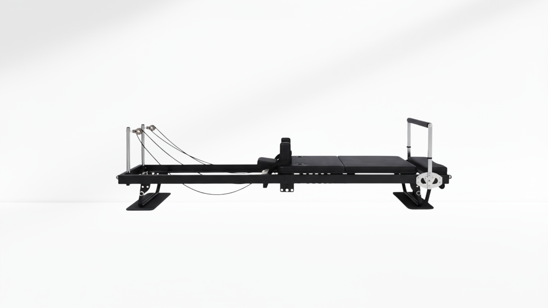 Black Pilates reformer core on a white background